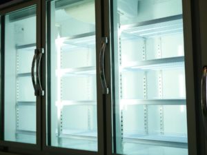 Large commercial refrigerators with glass doors and lighting inside