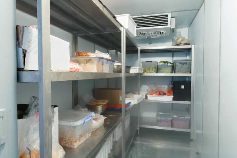 Restaurant walk-in cooler with food on shelves