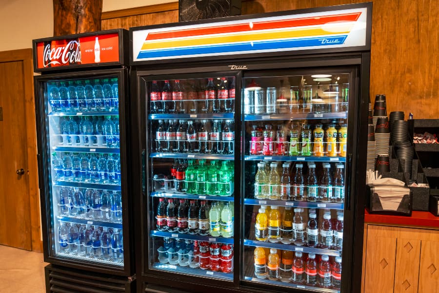 Two filled drink coolers inside convenience store