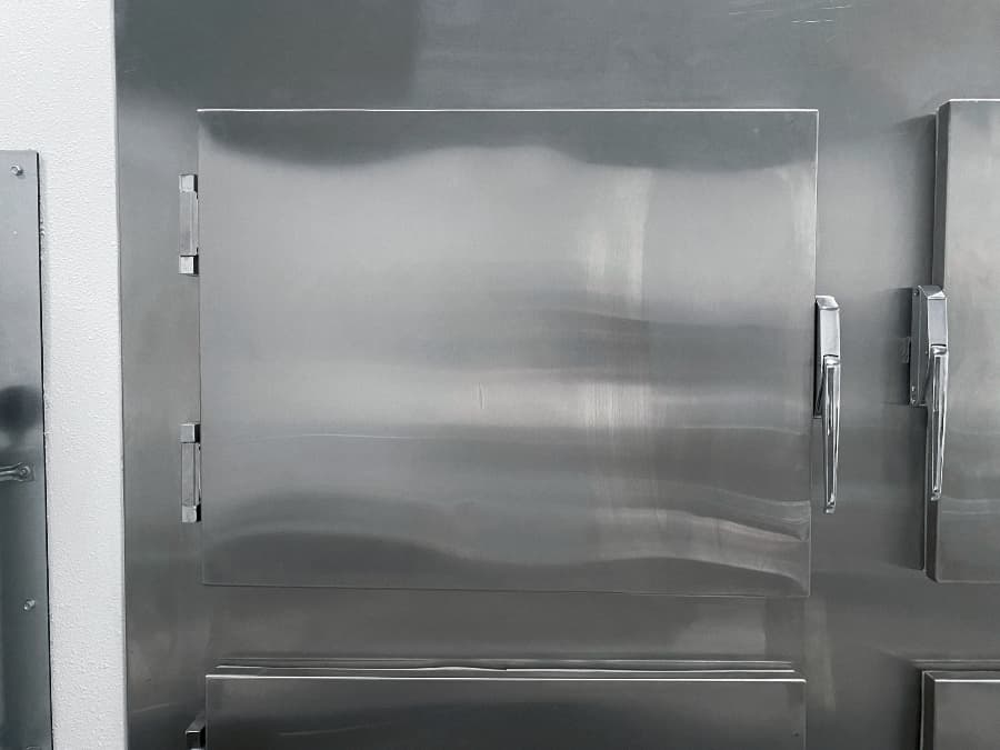 Mortuary cooler with storage compartment