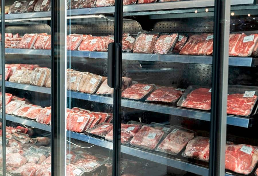 Different types of packaged meat in cooler